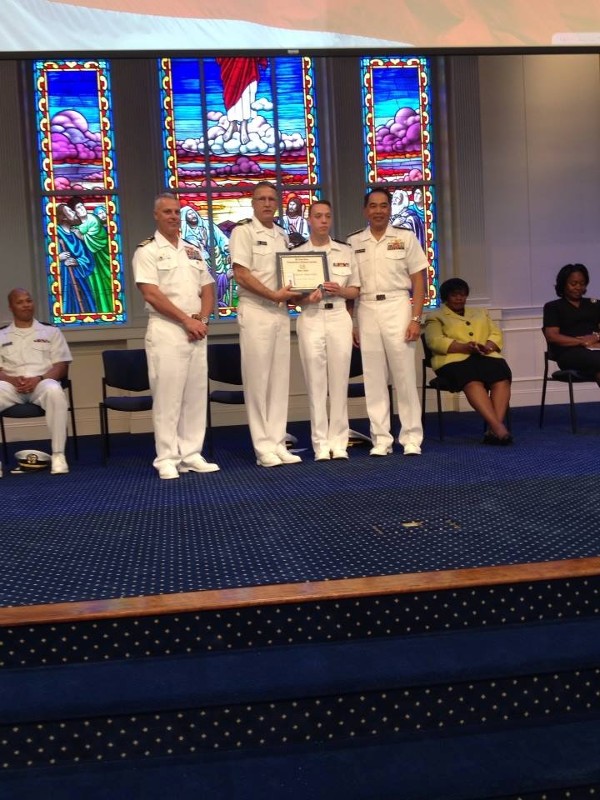 The Mid-Atlantic ROTC commanding officer (l); Lt. Cmdr. Doug Vanderlip, USN (2nd from l), chapter president; and Rear Adm. Pete A. Gumataotao, USN (r), commander, Naval Surface Force Atlantic, present the chapter's ROTC Honor Award to Midshipman Shawn Sides, Navy ROTC, at the April meeting.