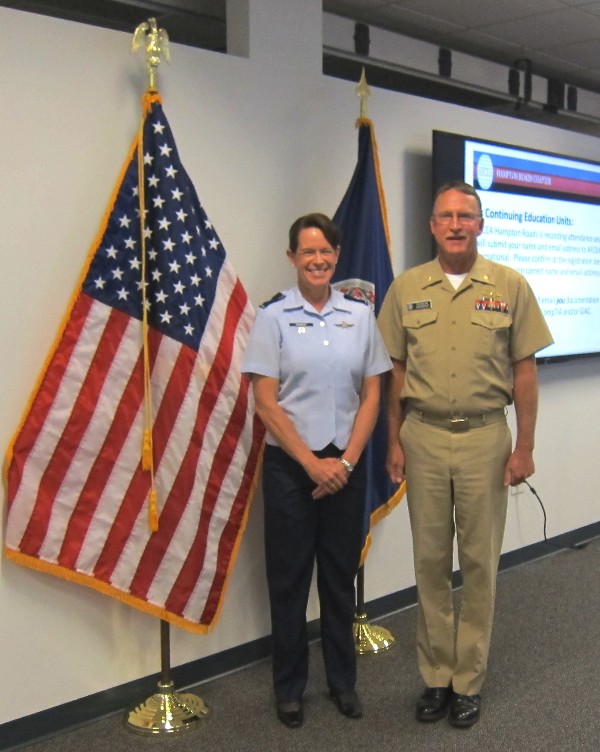 Lt. Col. Jenniffer Romero, USN, chapter vice president for military affairs, and Lt. Cmdr. Doug Vanderlip, USN, chapter president, greet each other at the Cyber Lunch and Learn in May.