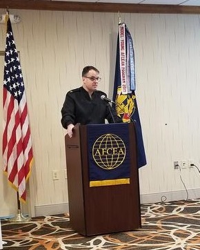 Capt. Jody H. Grady, USN, commanding officer, Naval Computer and Telecommunications Area Master Station Atlantic, presents at the chapter's luncheon in December.