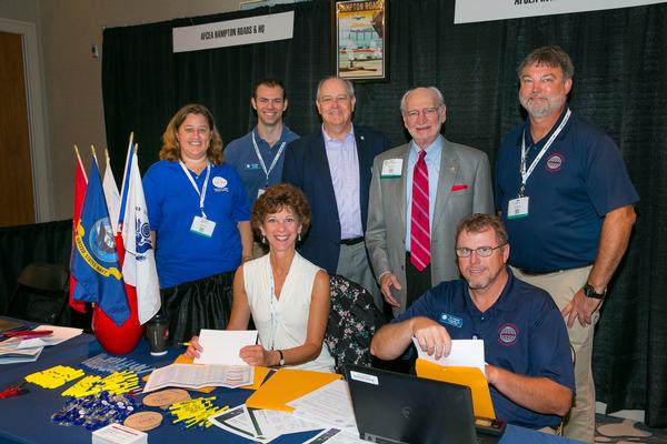 Volunteers at the chapter and AFCEA International membership tables pause for a photo at the June conference. Pictured are (back row, l-r) Hillary Boyce, Rhett Begley, Palmer Sims, Dave Johnson, Jim Tilley and (front row, l-r) Theresa Sims and Pat Crawford. 