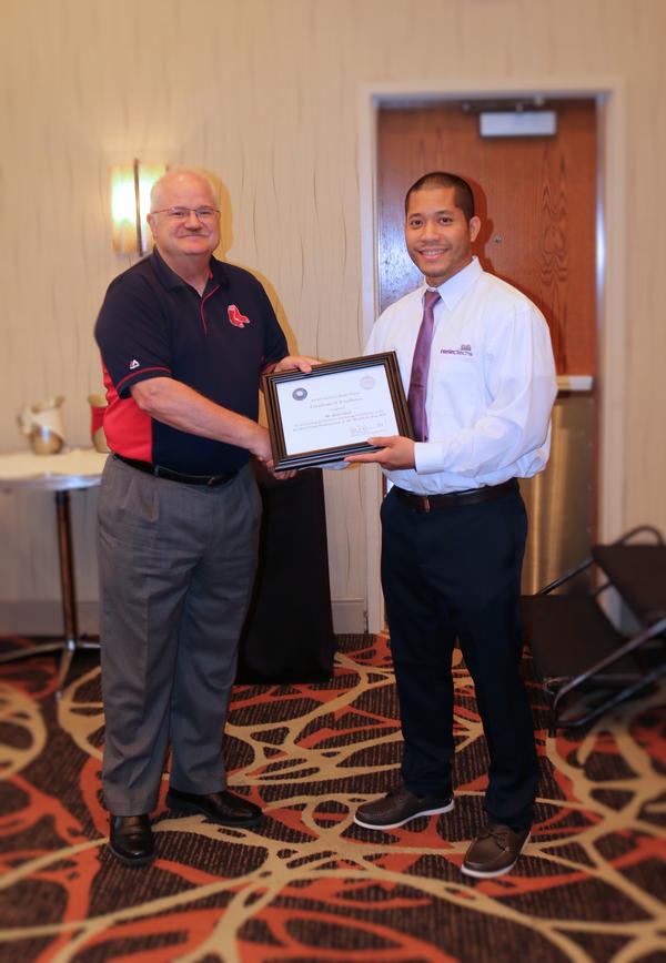 At the July luncheon, Neil Bourassa, chapter president, presents Brian Dinh, IntellecTechs (r), with an award for Civilian Cyber Professional of the Month.