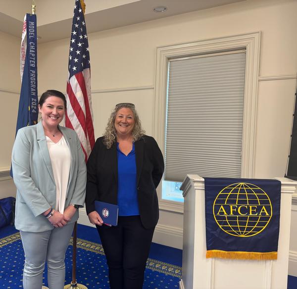 Caitlin Johnson (l), chapter president, stands with Julie Stark, science and technology manager for combatant craft at the Naval Surface Warfare Center, Carderock Division, and director of the NavalX Mid-Atlantic Tech Bridge, at the April luncheon.