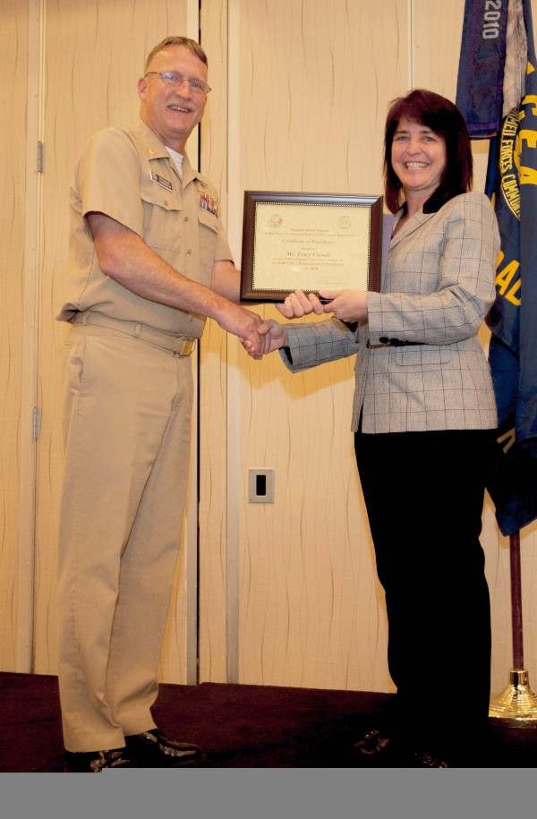 Lt. Cmdr. Doug Vanderlip, USN, chapter president, presents Carroll with the Civilian Cyber Professional of the Month award for March.