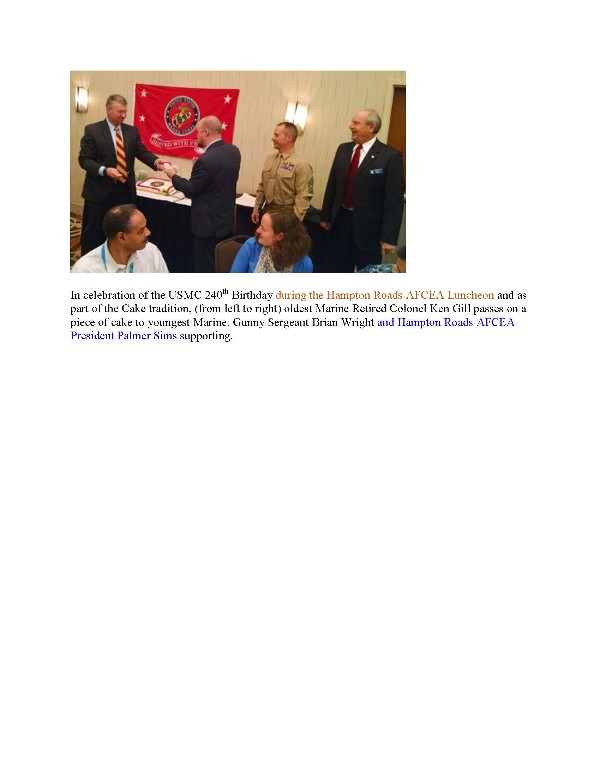 In celebration of the Marine Corps' 240th birthday during the November luncheon (l-r), the oldest Marine, Col. Ken Gill, USMC (Ret.), passes on a piece of cake to the youngest Marine, Gunnery Sgt. Brian Wright, USMC. Sims and another attendee look on.