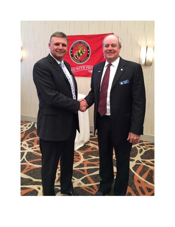 Col. Ronald M. Zich, USMC (Ret.) (l), shakes hands with Chapter President Palmer Sims during the December luncheon.