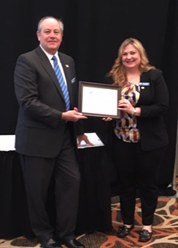 Sims presents the AFCEAN of the Month Award to Young AFCEAN President Christy Fanelli during the February luncheon.