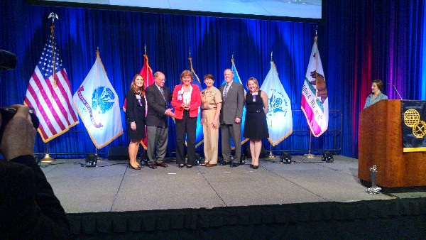 Duvall accepts her award at the 2016 AFCEA West Conference in March. 