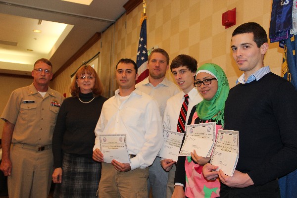 In November, Cmdr. Vanderlip (l) and Mary Yager (2nd from l), chapter vice president for education, present recognize Old Dominion University Student Chapter scholarship winners (3rd from left to right) Philip Irvine, Michael Thompson, Max Hall, Sawson Abutabenjah and Colin Dalton. 