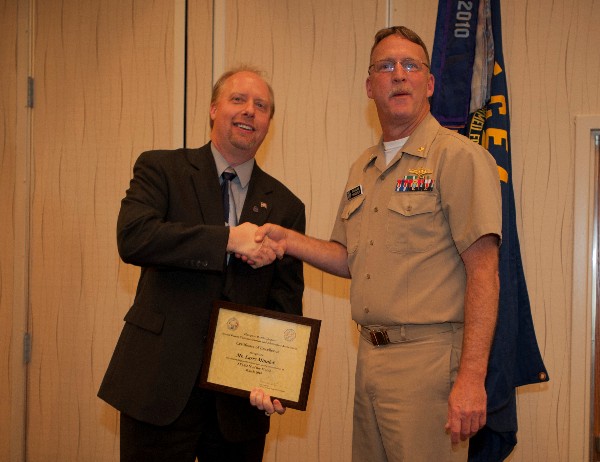 Larry Minnick, SBGTS (l), receives the AFCEAN of the Month Award from Cmdr. Vanderlip in March.