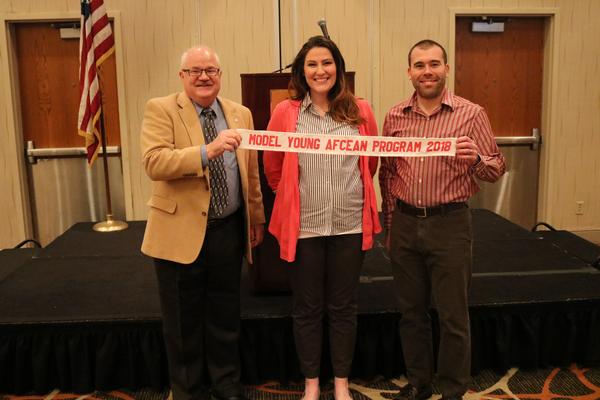 Bourassa (l) presents the 2018 Model AFCEAN Program Award to Young AFCEAN President Caitlin Johnson during the February luncheon.
