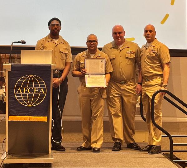 The January 2026 Team Cyber Professional of the Month, NCTAMS LANT UARNOC, show off the award. 