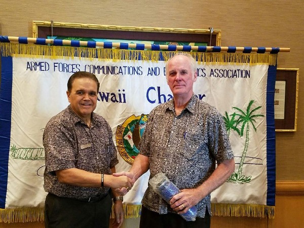 Cory Lindo, the chapter's chairman of the board (l), presents January guest speaker Peter Oleson of the Association of Former Intelligence Officers with a token of appreciation.
