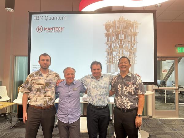 Representatives from MANTECH and IBM pose for a photo at the May event.