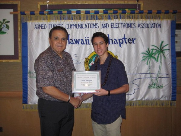 Lindo (l) presents the Student of the Month Award to Zion Basque of Kamehameha High School in January.