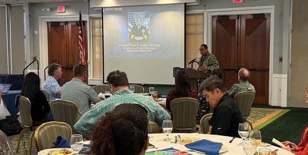 Taylor speaks to the August luncheon attendees.