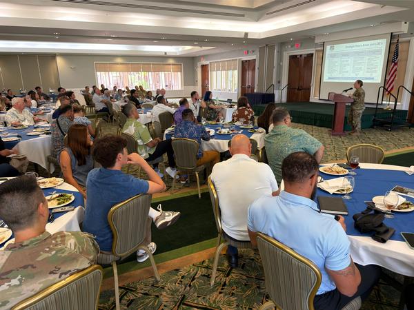 The attendees of July luncheon listen as Davis delivers the keynote.