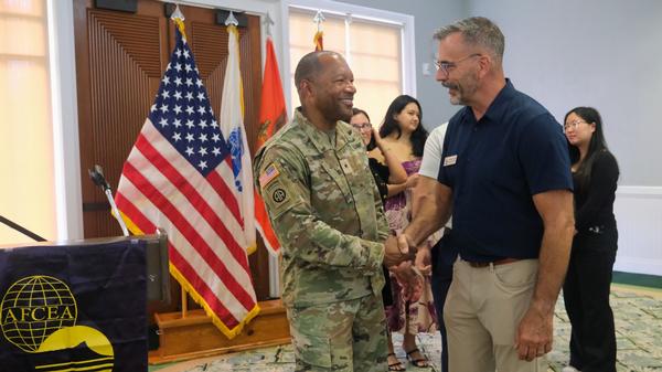 Brig. Gen. Tonri Brown, USAR (l), shakes hands with Col. Dick Palmieri, USAF, chapter president, in September.