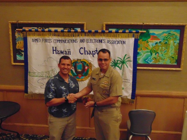 Chapter President Jim Muller welcomes guest speaker Capt. Jody Grady, USN, liaison officer, U.S. Cyber Command, United States Pacific Command to the chapter's September luncheon. 