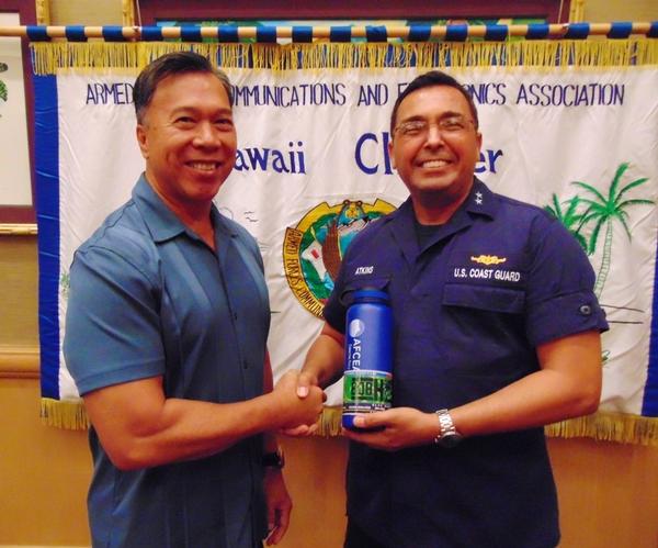 Guest speaker Rear Adm. Vincent Atkins, USCG, commander, District 14 (r), receives a token of appreciation from Barry Fong, chapter executive vice president, at the luncheon in September.