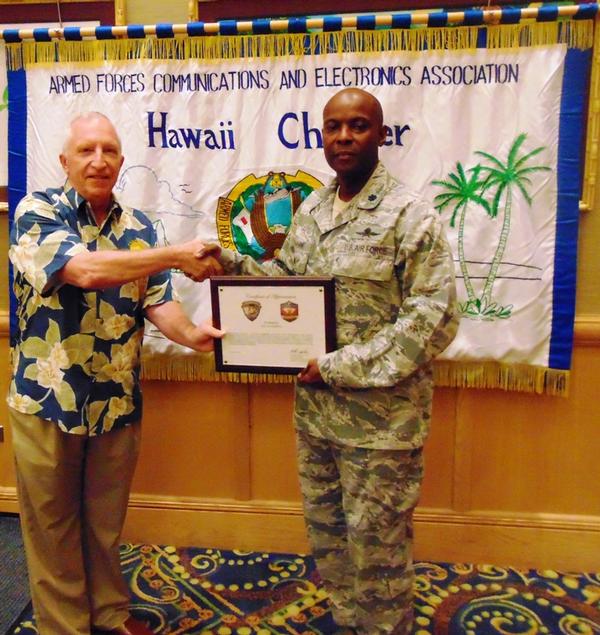 Chaplain Steve Jensen of Hawaii Wounded Warrior Battalion West (l) presents a plaque in February to Chapter President Lt. Col. Callistus Elbourne, USAF, in appreciation of the chapter's support over the years.