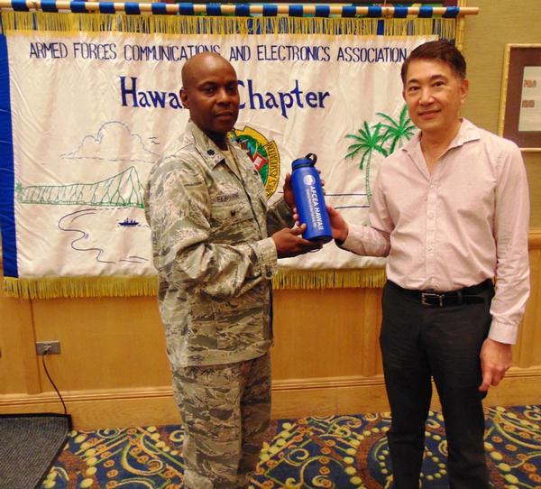 Chapter President Lt. Col. Callistus Elbourne, USAF (l), presents Mark Wong, chief information officer and director of the Department of Information Technology for the City and County of Honolulu, with a token of appreciation for speaking at the chapter's February luncheon.