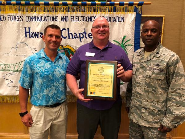 Lt. Col. Ed Ryglewicz, USAF (Ret.), AFCEA regional vice president, Pacific (c), accepts the chapter's Distinguished Life Member Award in March from Jim Muller, chapter chairman of the board (l), and Lt. Col. Callistus Elbourne, USAF, chapter president.