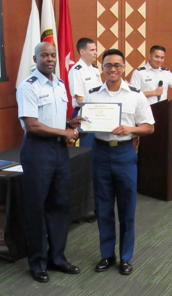 Chapter President Lt. Col. Callistus Elbourne, USAF (l), presents an AFCEA Honor Award to Cadet Dexter Manglicmot, Army ROTC, during a May ceremony at the University of Hawaii.