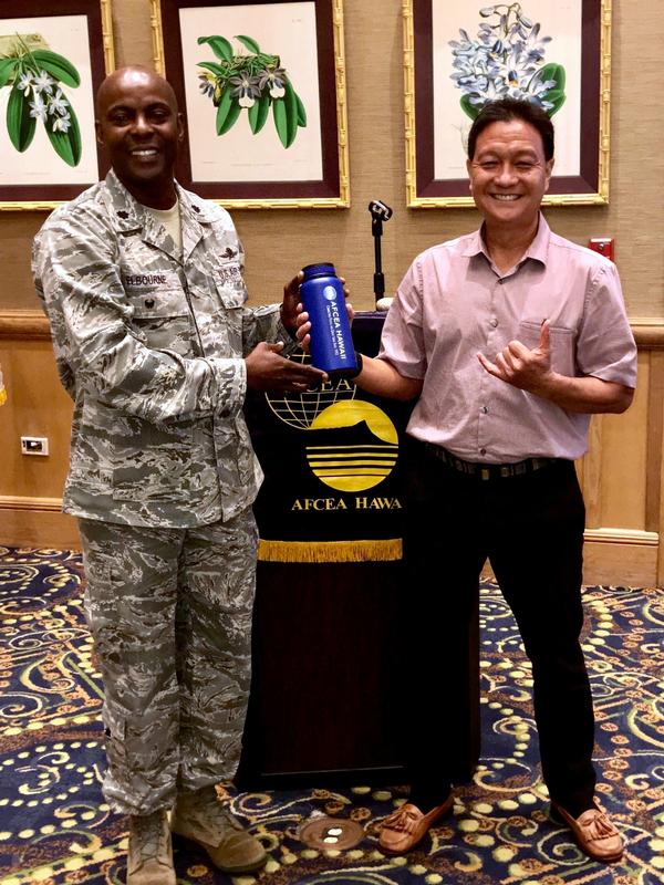 Chapter President Lt. Col. Callistus Elbourne, USAF (l), presents a token of appreciation to Burt Lum, strategy officer for the Hawaii Broadband Initiative, after his September presentation.