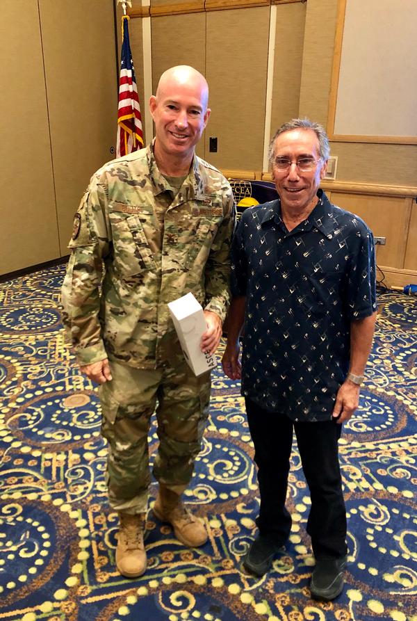 Col. Michael A. Boutet, USAF, individual mobilization augmentee (IMA), Headquarters Pacific Air Forces Command, A-3/6 director of Air and Cyberspace Operations, Joint Base Pearl Harbor–Hickam, Hawaii (l), pauses for a photo with Jeff Bloom, chapter president, at the June event.