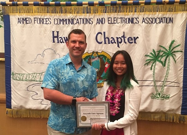 Muller congratulates the chapter's student of the month, Jacynth Tate Agraan, in February.