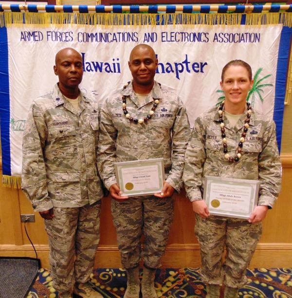 Col. Elbourne (l) presents certificates in February to AFCEAN of the Month Master Sgt. Lloyd Tate, USAF (c), and Young AFCEAN of the Month Master Sgt. Aliah Reyes, USAF.
