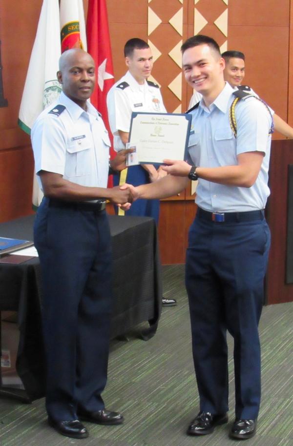 Col. Elbourne presents Cadet Darius DeSpain, Air Force ROTC, his AFCEA Honor Award in May at the University of Hawaii.