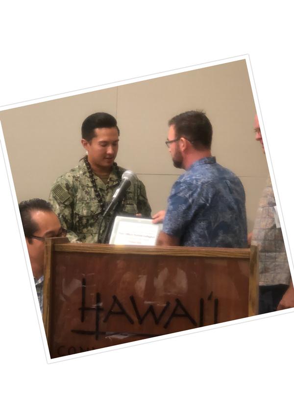 Young AFCEAN of the Month, Petty Officer Second Class Patrick Gallagher, USN, Naval Computer and Telecommunications Area Master Station-Pacific (l), accepts his award at the October event.