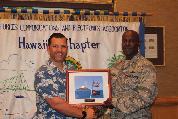 Chapter Chairman of the Board Jim Muller (l) presents a token of appreciation in April to Col. Elbourne for his service as executive vice president.