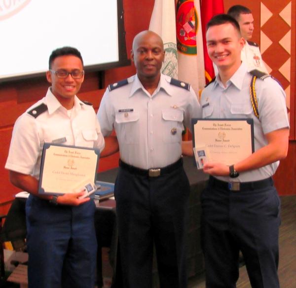 Col. Elbourne (c) congratulates Cadets Manglicmot (l) and DeSpain on their AFCEA awards during the May ceremony. 
