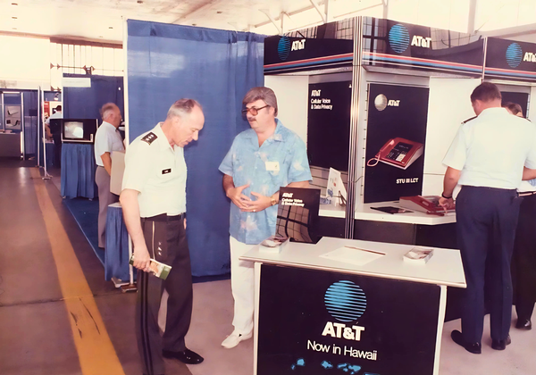 Lt. Gen. Vaughn O. Lang, USA (l), stands at the AT&T booth during the 1986 conference. Lang was the USCINCPAC J6 prior to Lynn.