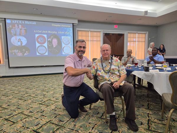 In August, Palmieri presents Murphy with a chapter mug in gratitude for his 33 years of service to AFCEA before moving to the mainland.