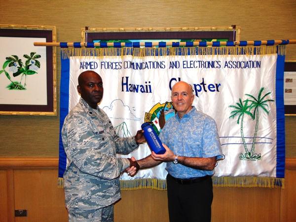 Chapter President Lt. Col. Callistus Elbourne, USAF (l), presents a token of appreciation to the chapter's May guest speaker Bryan Tepper of the Hawaiian Electric Company (HECO).