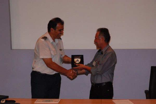 Col. S. Amourgianos, HEAF (l), and Lt. Gen. Leonidas Mazarakis, HAF (Ret.), chapter president, exchange a token of appreciation at the June seminar.