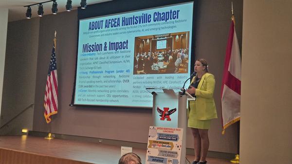 Chapter President Jessica Washburn speaks to the June Luncheon attendees on the chapter's activities.