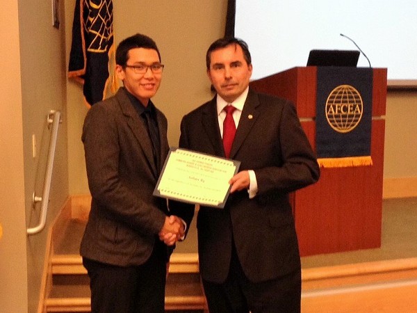 In February, Bruce Shaw (r), chapter scholarship chair, presents a $2,500 scholarship to Julian Sy, a junior at the University of Alabama in Huntsville.