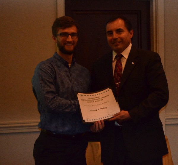 Bruce Shaw, chapter scholarship director (r), recognizes scholarship recipient Jeremy Pohly at the chapter's August luncheon.