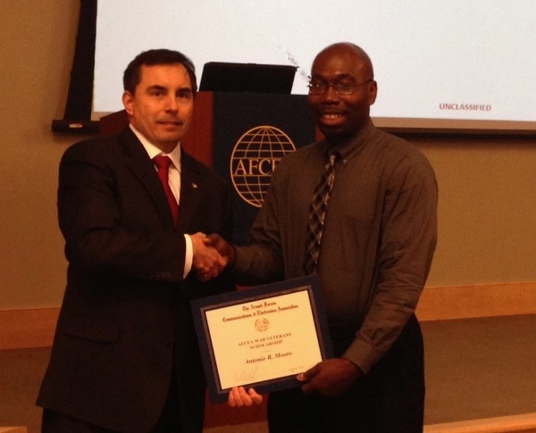 Antonio Moore (r) receives a $5,000 National AFCEA Scholarship for Veterans of Iraqi Freedom and Enduring Freedom from Shaw in February.