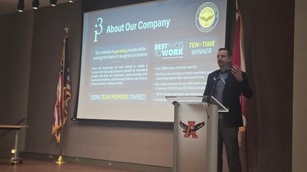 February Industry Partner David King, vice president of cyber, Resiliency, Electronic Warfare Systems (CREWS) for i3, speaks to the attendees on i3 services and capabilities.