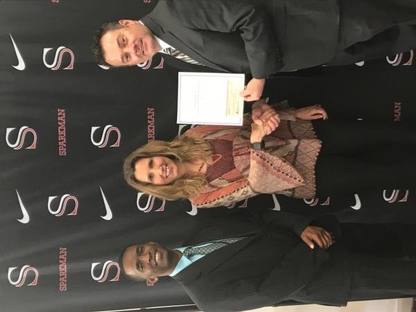 Nivens (r) and Perkins (l) present a grant in May to Sparkman High School's Teresa Hodge, who coaches the CyberPatriot club and teaches robotics, AP programming and the Innovative System Project for the Increased Recruitment of Emerging STEM Students (InSPIRESS) classes.