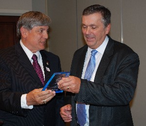 Jeff Dowdy (r), special agent, Federal Bureau of Investigation, accepts a token of thanks from Vic Budura, chapter president, for speaking during the April meeting.