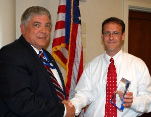 Paul A. Gierow (r), president, GATR Technologies, receives a token of appreciation from Vic Budura, chapter president, at the May meeting.
