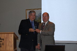 Alan Goldstayn (r), U.S. Army Space and Missile Defense Command, receives a token of appreciation for his November presentation from Vic Budura, chapter vice president of programs.