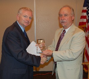 In September, Dr. Mark Swinson (l), director, Space and Cyberspace Technology Directorate, U.S. Army Space and Missile Defense Command Technology Center, receives a token of appreciation from Michael Schexnayder, chapter vice president for programs.