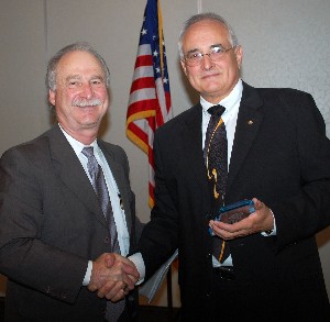 Mike Schexnayder (l), chapter vice president for programs, presents Richard Brown, vice president of Jacobs Technology, with a token of appreciation for serving as the November meeting's guest speaker.